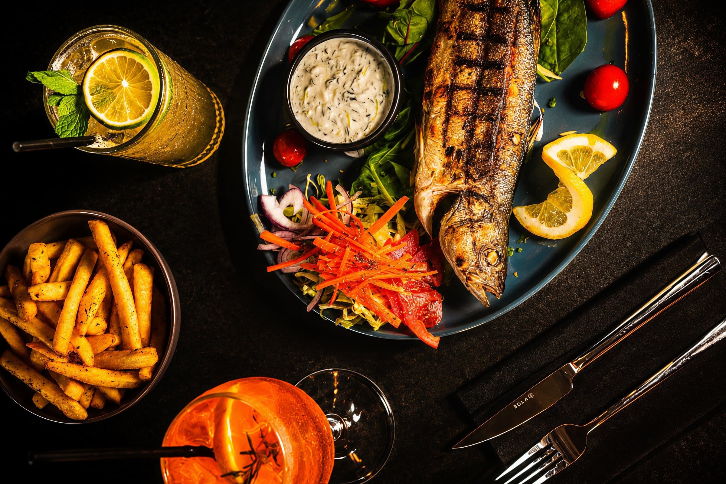 Grilled whole fish with fries and salad at Kreta, Greek restaurant in Paceville Malta